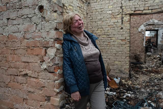 Inna, 53, cries inside her burnt house on April 25, 2022 in Ozera, Ukraine (Photo: Getty)