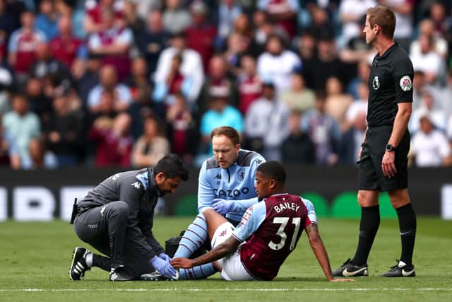 Leon Bailey of Aston Villa receives medical treatment during the Premier League match between Aston Villa and Norwich City at Villa Park