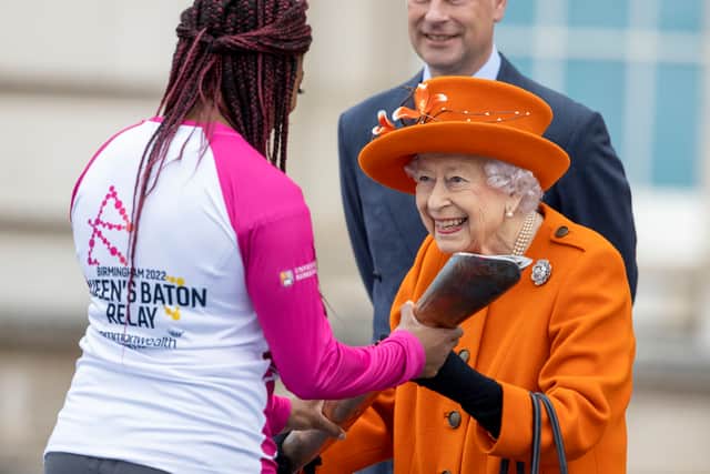 The Queen presenting the baton to athlete Kadeena Cox at the beginning of the Birmingham 2022 Queen’s Baton Relay