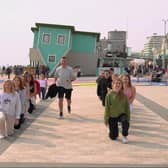 The  heart-warming moment a Birmingham man proposed to his girlfriend of nine years with a surprise flash mob in front of the Upside Down House in Brighton