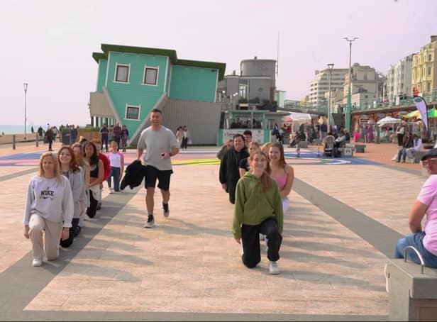 <p>The  heart-warming moment a Birmingham man proposed to his girlfriend of nine years with a surprise flash mob in front of the Upside Down House in Brighton</p>