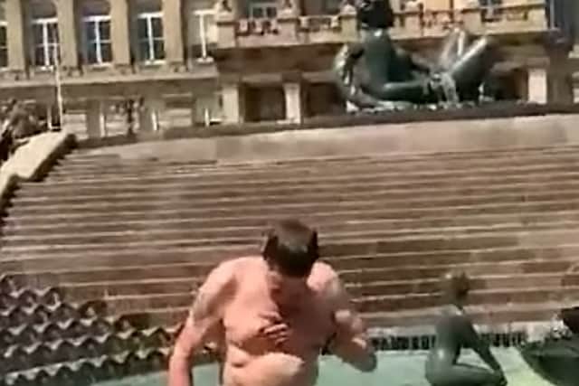 Fun in the Brum: man goes for a dip in the Floozie in the Jacuzzi in Victoria Square, Birmingham, in the hot weather