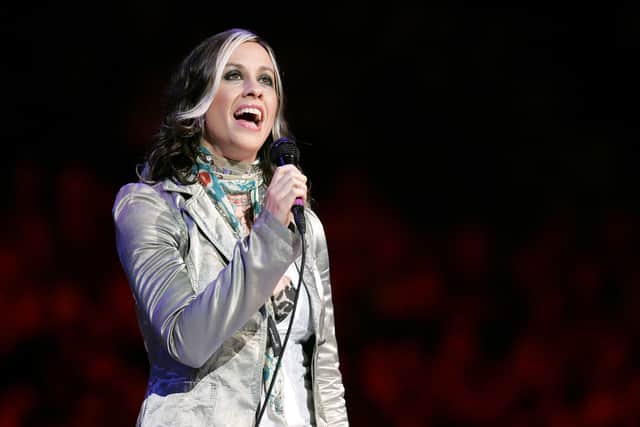 Singer Alanis Morissette performs the national anthem before the start of the game between the San Antonio Spurs of the Detroit Pistons