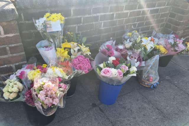 Flowers left in memory of Birmingham gas explosion victim grandmother Doreen Rees-Bibb on Dulwich Road, Kingstanding