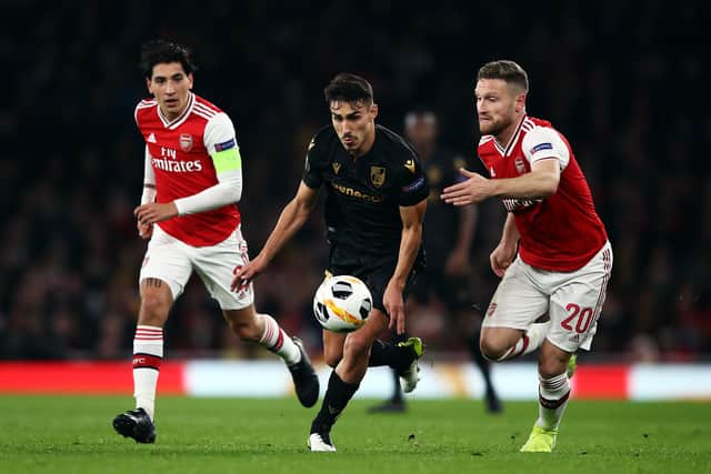 Hector Bellerin (l) of Arsenal and team mate Shkodran Mustafi (r) battle with Andre Almeida of Vitoria Guimaraes during the UEFA Europa League group F match between Arsenal FC and Vitoria Guimaraes at Emirates Stadium on October 24, 2019