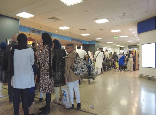 <p>Passengers queue at Birmingham Airport</p>