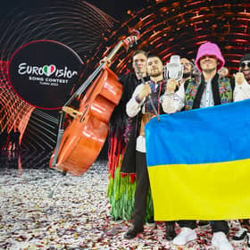 Members of the band "Kalush Orchestra" pose onstage with the winner's trophy and Ukraine's flags after winning on behalf of Ukraine the Eurovision Song contest 2022 