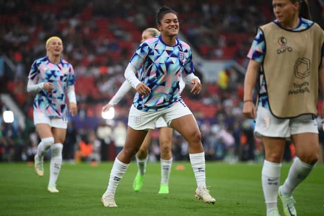 England's defender Jessica Carter (C) warms up ahead of the UEFA Women's Euro 2022 Group A football match between England and Austria at Old Trafford in Manchester