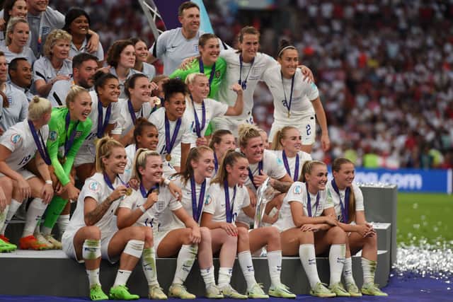 Players of England pose with the UEFA Women’s EURO 2022 Trophy after the final whistle of the UEFA Women’s Euro 2022 final match with Germany at Wembley Stadium on July 31, 2022