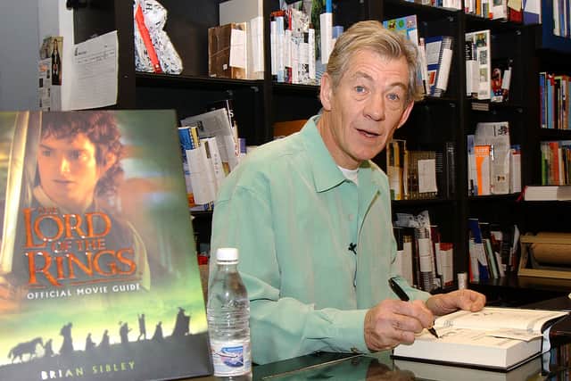 Actor Sir Ian McKellen autographs “The Lord of the Rings” official movie guide at Book Soup January 19, 2002.
