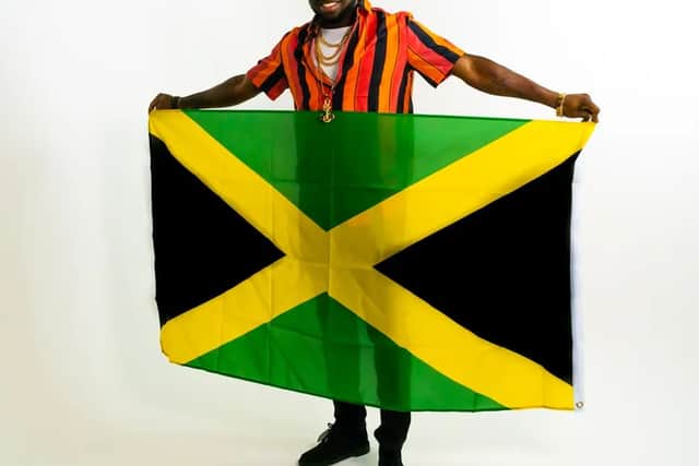 Lawdgad holding Jamaican flag 