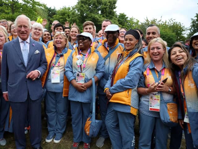 Prince Charles, Prince of Wales poses for pictures with Commonwealth Games volunteers during a visit to the Athletes Village at The University of Birmingham