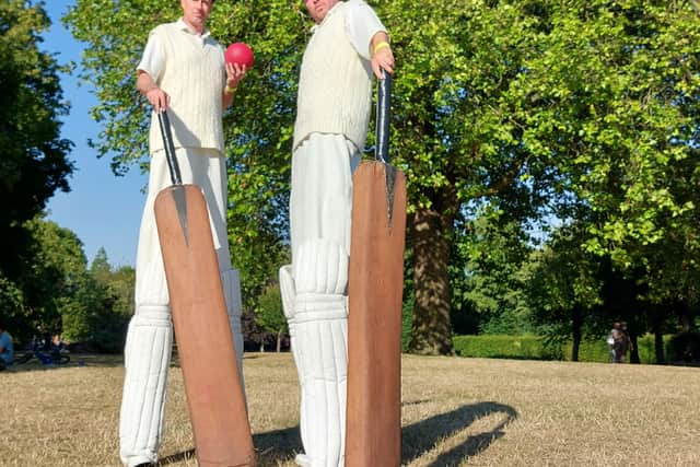 Giant athletes pose in their cricket attire