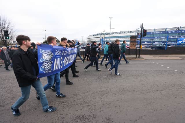 Fans of Birmingham City walk towards the stadium holding a protest banner prior the Sky Bet Championship match between Birmingham City and Barnsley at St Andrew’s Trillion Trophy Stadium on January 22, 2022 in Birmingham, England. (Photo by Marc Atkins/Getty Images)