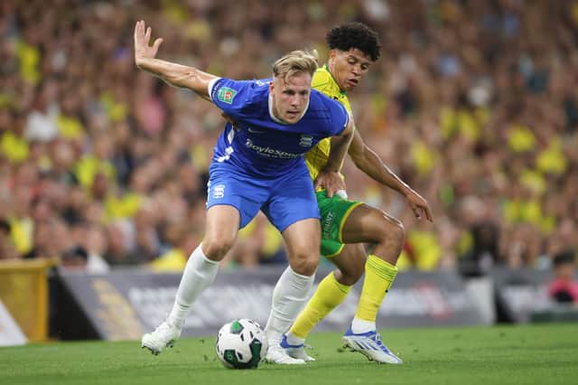 Marc Roberts of Birmingham City in action with Gabriel Sara of Norwich City  during the Carabao Cup First Round match between Norwich City and Birmingham City at Carrow Road 