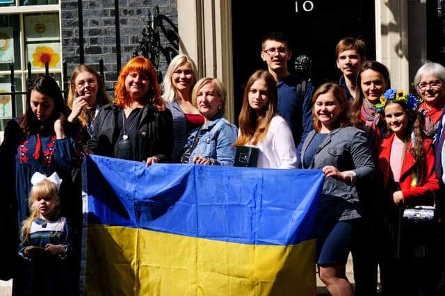 A number of Ukrainian families stand on the doorstep of 10 Downing Street after they met with Prime Minister Boris Johnson after arriving to the UK through the UK visa scheme.