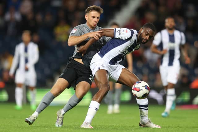 Mark Harris of Cardiff City is challenged by Semi Ajayi of West Bromwich Albion during the Sky Bet Championship between West Bromwich Albion and Cardiff City