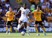 Tosin Adarabioyo of Fulham is challenged by Hwang Hee-Chan during the Premier League match between Wolverhampton Wanderers and Fulham 