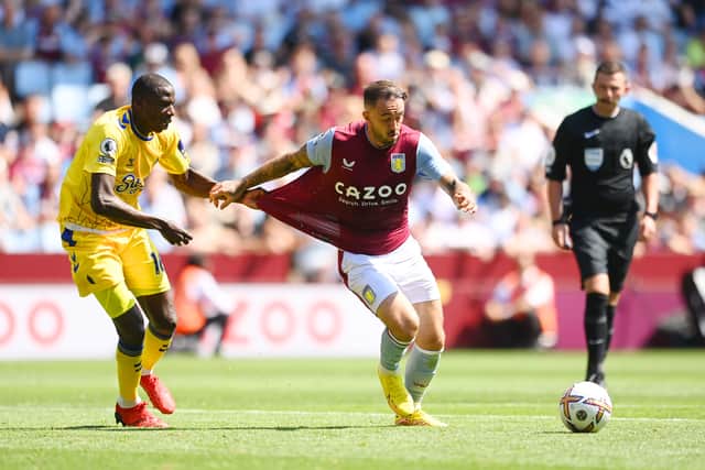 Abdoulaye Doucoure of Everton pulls back Danny Ings of Villa as he shoots and scores the first goal 