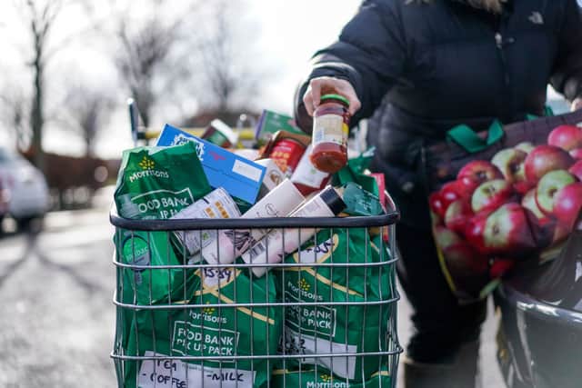 A volunteer with Community for Food, is seen unpacking donations from Morrisons supermarket on February 25, 2022 in Edinburgh, Scotland. (Photo by Peter Summers/Getty Images)