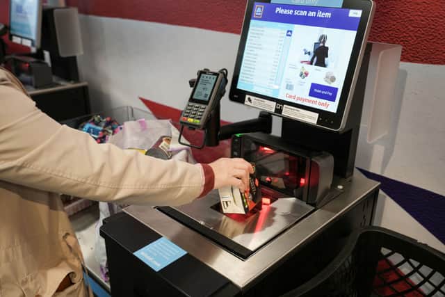 A customer uses a self checkout terminal at the new Tarleton Aldi store on July 22, 2022  (Photo by Christopher Furlong/Getty Images)
