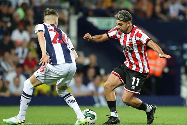 Reda Khadra of Sheffield United takes on Zac Ashworth during the Carabao Cup First Round match between West Bromwich Albion and Sheffield United at The Hawthorns