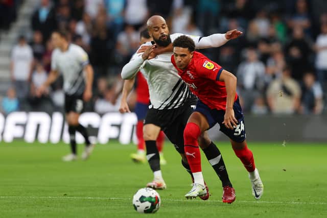 Ethan Ingram of West Bromwich Albion holds off David McGoldrick of Derby County during the Carabao Cup Second Round match between Derby County and West Bromwich Albion at Pride Park Stadium