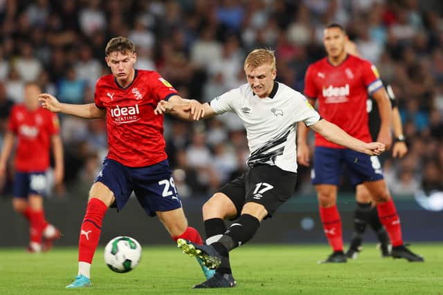 Louie Sibley of Derby County takes a shot whilst under pressure from Taylor Gardner-Hickman of West Bromwich Albion during the Carabao Cup Second Round match between Derby County and West Bromwich Albion 