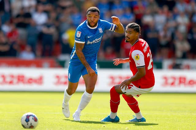 Troy Deeney of Birmingham City competes with Cameron Humphreys of Rotherham United during the Sky Bet Championship between Rotherham United and Birmingham City