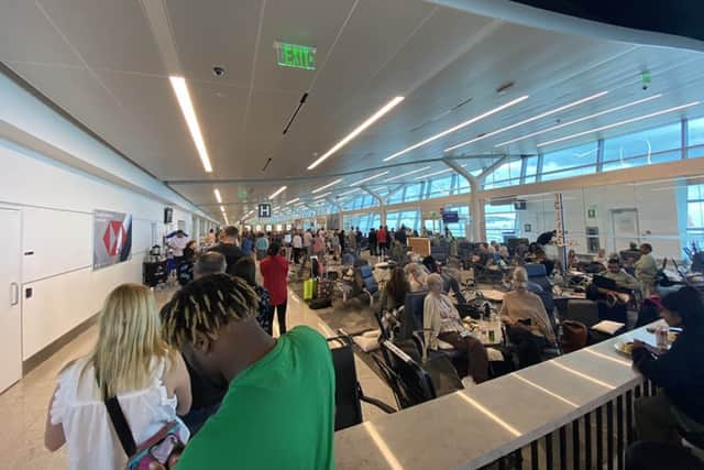 Passengers at L.F. Wade International Airport in St.George’s, Bermuda, after their American Airlines flight from Miami to London had to divert due to a possible mechanical issue