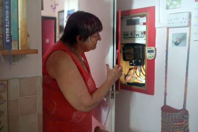 Pensioner Diane Skidmore examines her smart meter in London on August 25, 2022. Photo by SUSANNAH IRELAND/AFP via Getty Images