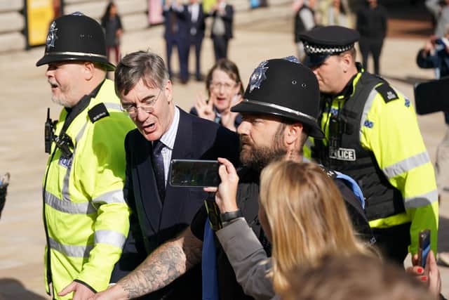 Jacob Rees-Mogg is escorted by police at the Conservative Party annual conference (PA)