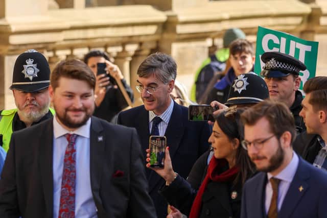 Jacob Rees-Mogg ) looks at a photographer as he arrives to attend the opening day of the annual Conservative Party Conference in Birmingham