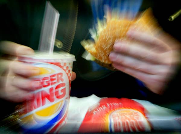  A man eats his lunch at a Burger King restaurant.