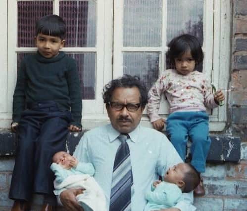 Baabzi Miah (in black) pictured with younger sister Salina and his grandad Mozamil holding brother Reed and late sister Sabina