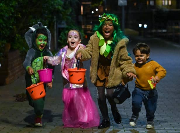 <p>Children pose for a picture as they go trick-or-treating for Halloween in east London. </p>