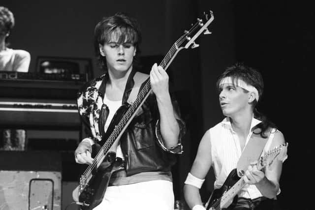 Bassist John Taylor and guitarist Andy Taylor of Duran Duran perform on stage at Wembley Arena in London, England on December 19, 1983. (Photo by Rogers/Express/Getty Images)