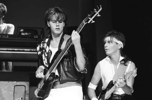 Bassist John Taylor and guitarist Andy Taylor of Duran Duran perform on stage at Wembley Arena in London, England on December 19, 1983. (Photo by Rogers/Express/Getty Images)