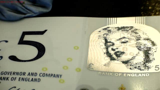A miniature portrait of Marilyn Monroe created by punching more than 2,300 tiny dotted holes through a £5 note by micro engraver Graham Short from Bournville, Birmingham