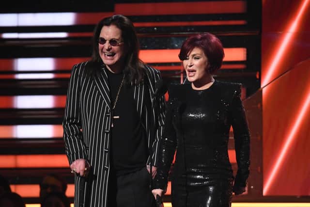 Ozzy Osbourne (L) and wife British television personality Sharon Osbourne present the award for Best Rap/Sung Performance during the 62nd Annual Grammy Awards on January 26, 2020, in Los Angeles. (Photo by Robyn Beck / AFP) (Photo by ROBYN BECK/AFP via Getty Images)