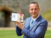  Martin Lewis poses with his CBE (Getty Images)