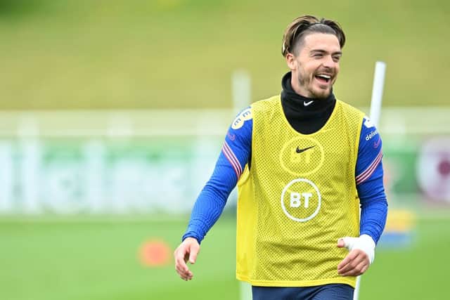 Jack Grealish laughs during a training session (Photo by JUSTIN TALLIS/AFP via Getty Images)