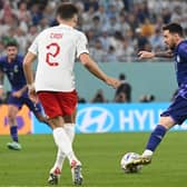 Lionel Messi takes on Aston Villa right-back Matty Cash during Poland 0-2 Argentina.
