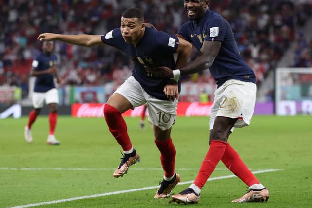 Marcus Thuram (right) celebrates with France teammate Kylian Mbappe (left) at the FIFA World Cup in Qatar.