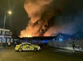 Emergency services tackle a fire in derelict warehouses in the Lower Horsley Fields area of Wolverhampton on 6 December 2022 