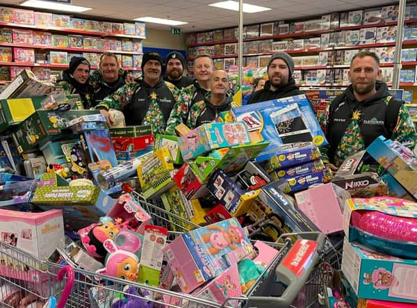 Reese, far right, and his team with some of hundreds of toys they bough from Smyth's Toy Shop