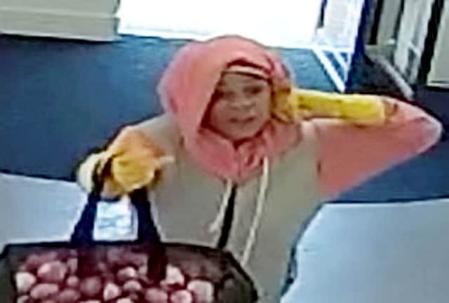 Police are hunting for a woman who tried to rob a bank in Birmingham wearing yellow rubber washing up gloves