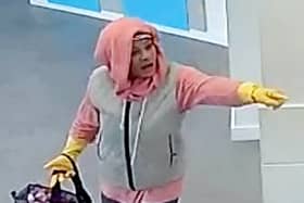West Midlands Police are hunting for a woman who tried to rob a bank wearing yellow rubber washing up gloves