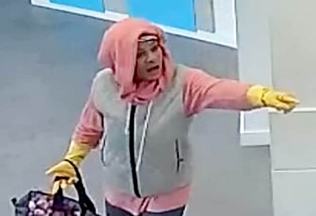 West Midlands Police are hunting for a woman who tried to rob a bank wearing yellow rubber washing up gloves