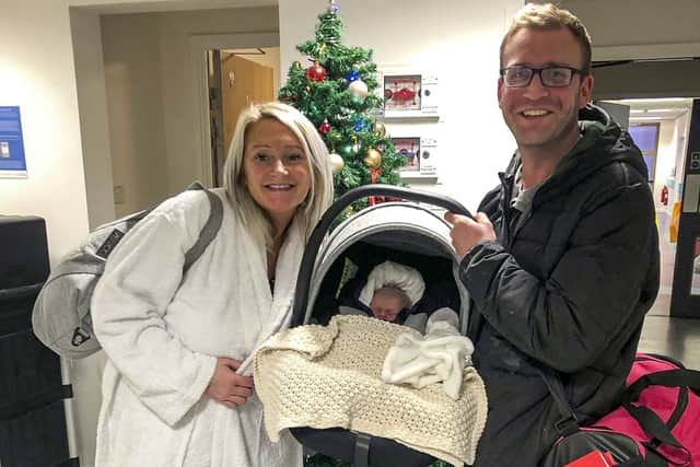 Phil and Hannah leaving the hospital on 30 Dec with Ruby-Lu after giving birth on their home driveway
